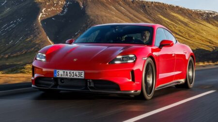 Porsche Taycan electric sedan driving on a modern road