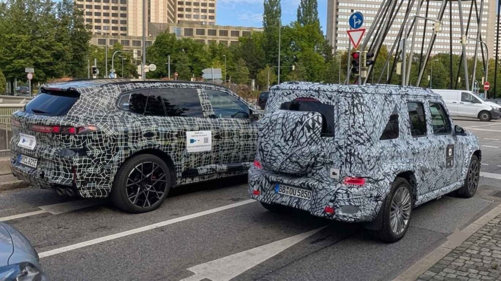 2027 BMW X5 M Prototype Towers Over Mercedes’ Smaller G-Class in Munich Camouflaged 2027 BMW X5 M prototype beside smaller Mercedes G-Class prototype in Munich