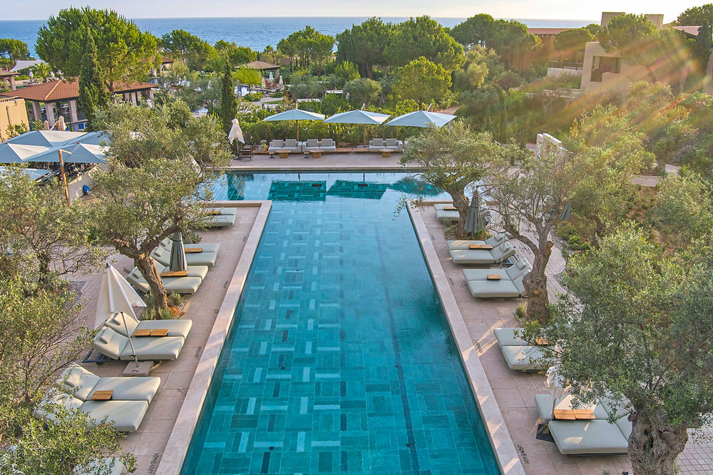 Costa Navarino Makes the Peloponnese a Mediterranean Summer Playground Costa Navarino coastline in Messinia with olive groves, resort pools and the Ionian Sea