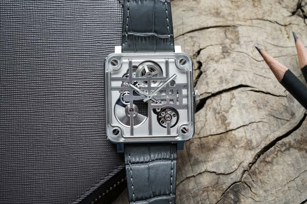 Bell & Ross BR-X3 Micro-Rotor Turns the Square Watch Into Architecture Bell & Ross BR-X3 Micro-Rotor skeleton watch with square steel and sapphire case on grey leather strap