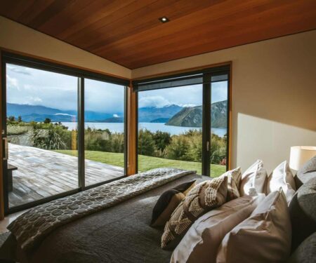 Wānaka Is the South Island Escape Couples Should Plan Properly Couple looking across Lake Wānaka toward the Southern Alps at sunrise