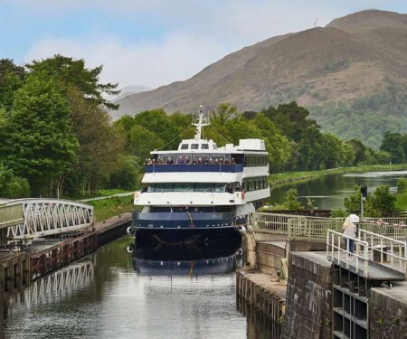Ten reasons Lord of the Highlands is a standout Scottish cruise Lord of the Highlands sailing through the Scottish Highlands on a calm canal with mountains beyond