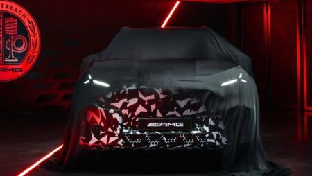Camouflaged Mercedes-AMG electric performance SUV preview showing the front end and LED lighting
