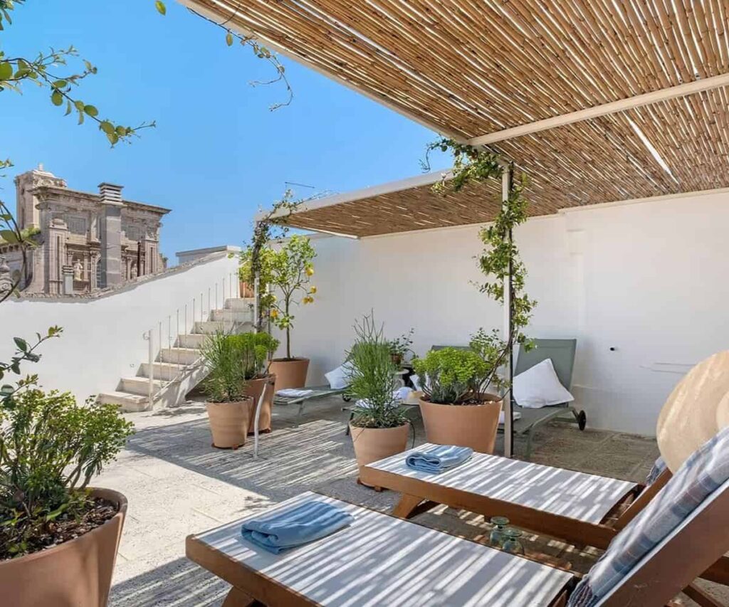 Inside Salento’s New Palazzo Stay Culture Restored palazzo rooftop terrace overlooking a historic town in Salento, Puglia