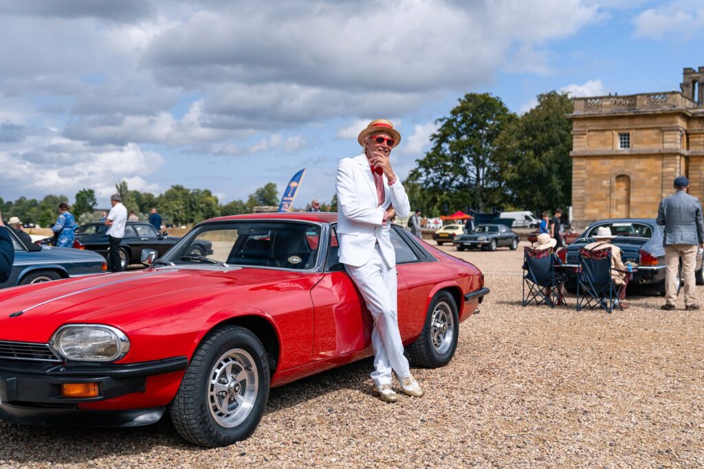 Well-dressed gentlemen at a luxury automotive garden party on the lawns of Blenheim Palace