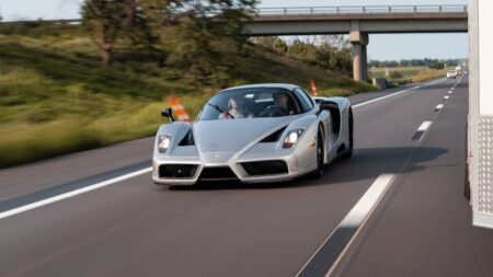 A Ferrari Enzo Is Crossing America for Cancer Patients Ferrari Enzo driving on an open American highway during a cross-country charity run