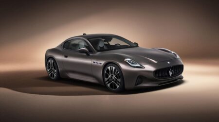 Maserati electric SUV and grand tourer concept silhouette in a modern Chinese EV factory