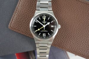 Luxury travel watches arranged with a passport and boarding pass