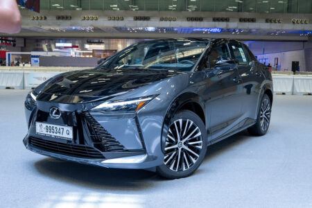 Lexus RZ 500e and Toyota Land Cruiser 300 HEV displayed at an electric mobility forum in Doha