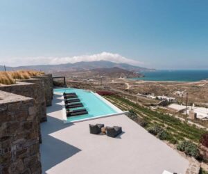 A modern eco-friendly luxury villa overlooking the Mediterranean with native planting and solar panels
