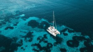 Catamaran sailing along Croatia’s Dalmatian coast near clear blue island waters