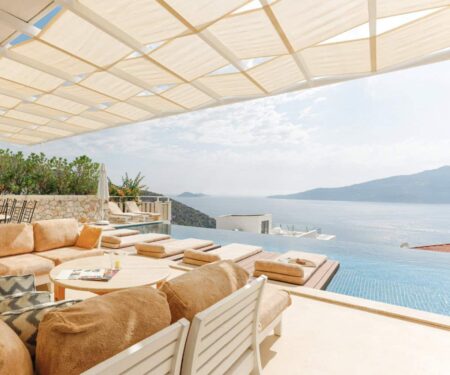 Luxury Mediterranean villa terrace with pool overlooking the sea at golden hour