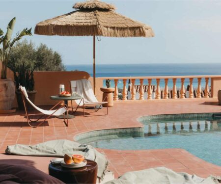 Mediterranean villa terrace with pool and sea view in soft September light
