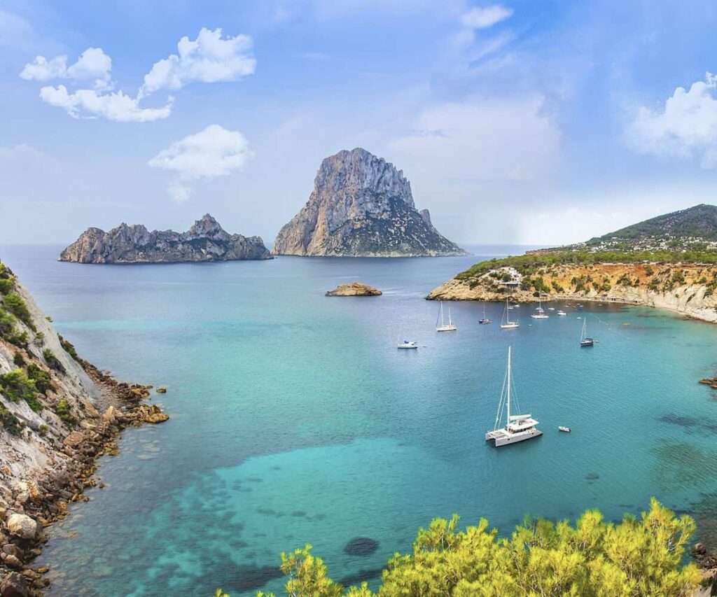 Golden late-summer sunset over the Ibiza coastline with boats on the Mediterranean