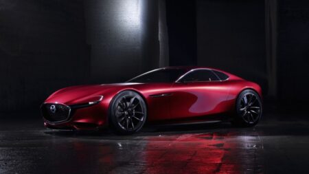 Mazda Keeps Combustion Engines in the Conversation Mazda concept car silhouette with an engine detail and electric charging motif