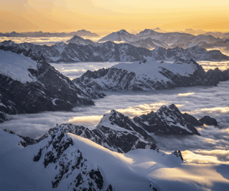 Private guide and travellers looking across a dramatic New Zealand mountain and coastal landscape
