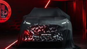 Teaser-style view of a Mercedes-AMG electric SUV with illuminated grille and LED lights