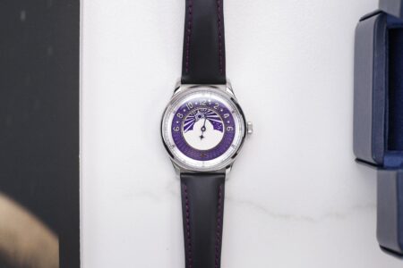 Metrical Epiphany Twilight watch with purple sun and moon display on a black leather strap