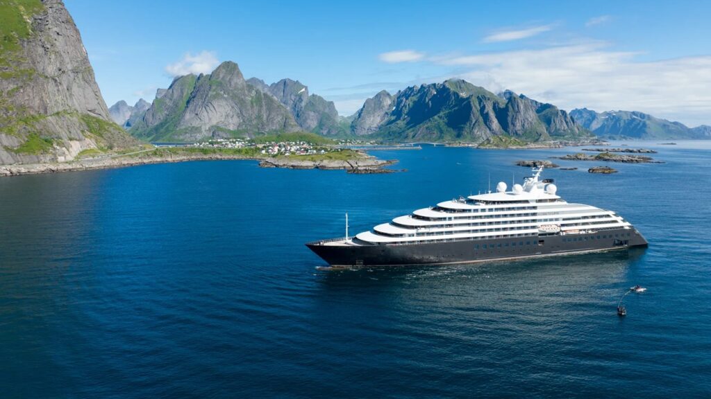 Luxury expedition cruise ship sailing through polar waters at sunset