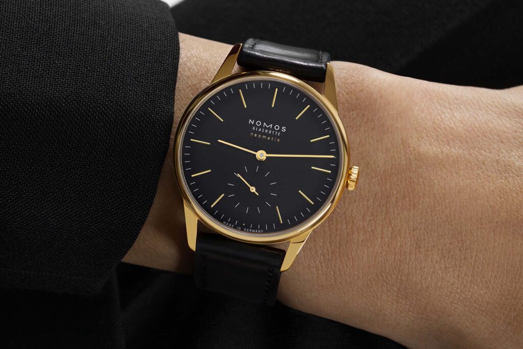 Nomos Orion Gold Neomatik New Black with yellow gold case and black dial