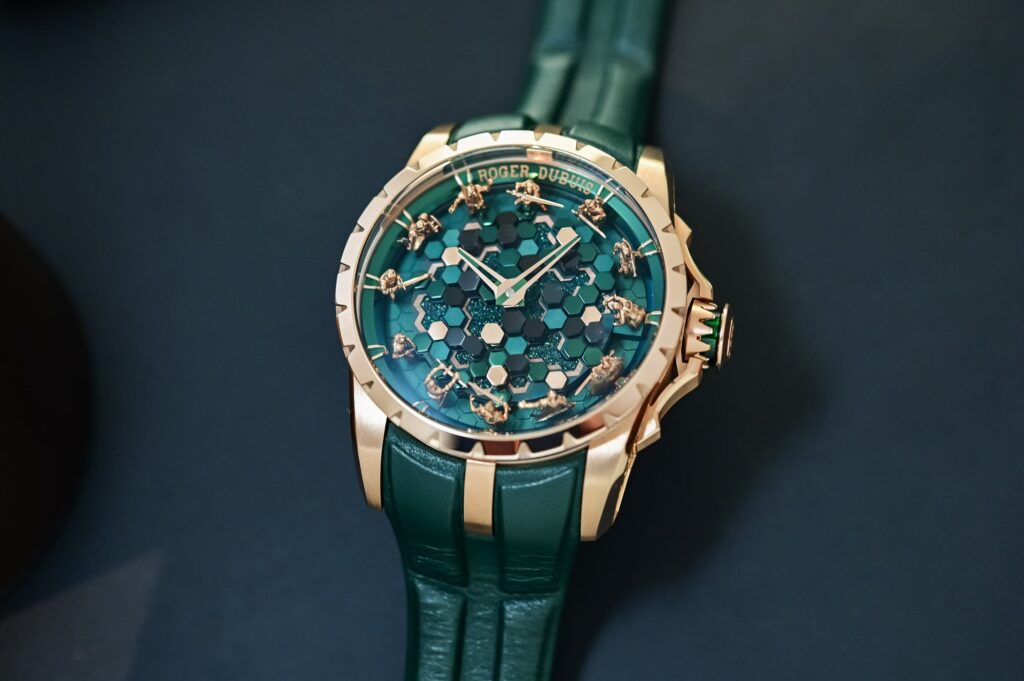 Roger Dubuis Brings Merlin’s Shape-Shifting Legend to the Knights of the Round Table Roger Dubuis Knights of the Round Table Metamorph Merlin watch in pink gold with green sculptural dial and miniature knights