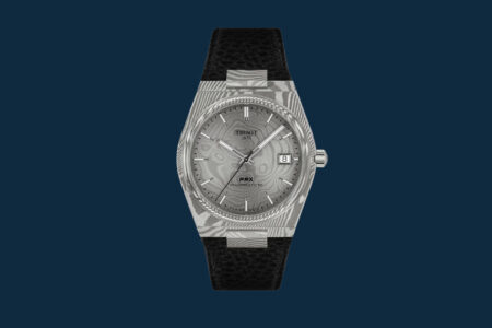 The Watch Auctions and Events to Know in September 2026 Collectors viewing luxury watches at a watch event with classic cars in the background