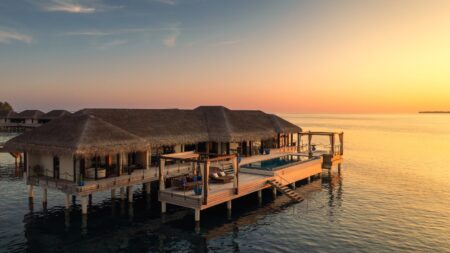 Aerial view of overwater villas and turquoise lagoon at Velaa Private Island in the Maldives