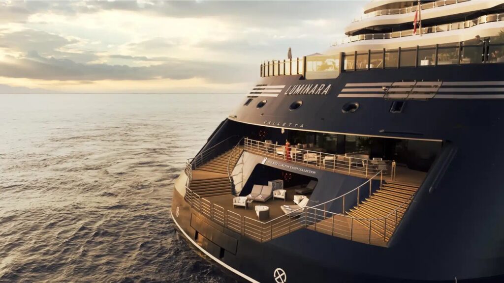 The Ritz-Carlton Yacht Collection yacht sailing through a scenic coastal destination