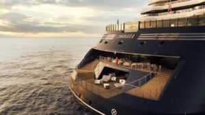 The Ritz-Carlton Yacht Collection yacht sailing through a scenic coastal destination