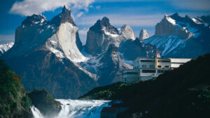 Luxury wilderness lodge overlooking a remote natural landscape at sunset