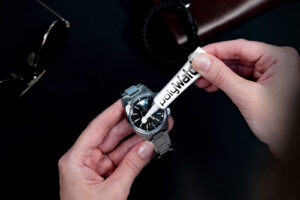 A curated selection of luxury watch accessories including leather cases, watch winders and polishing tools