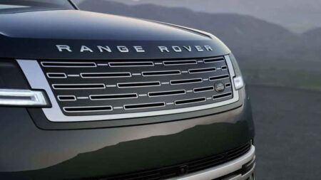 Range Rover Is Choosing Scarcity Over Sales Volume Range Rover luxury SUV positioned outside a modern private residence