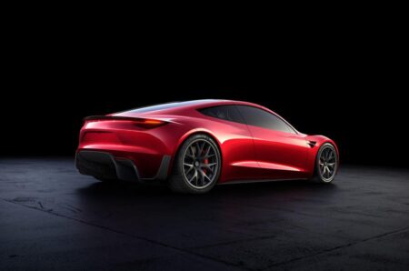 Tesla Roadster Tease Shows a New Light Signature Before October Debut Tesla Roadster front end teaser showing a full-width LED light bar in darkness