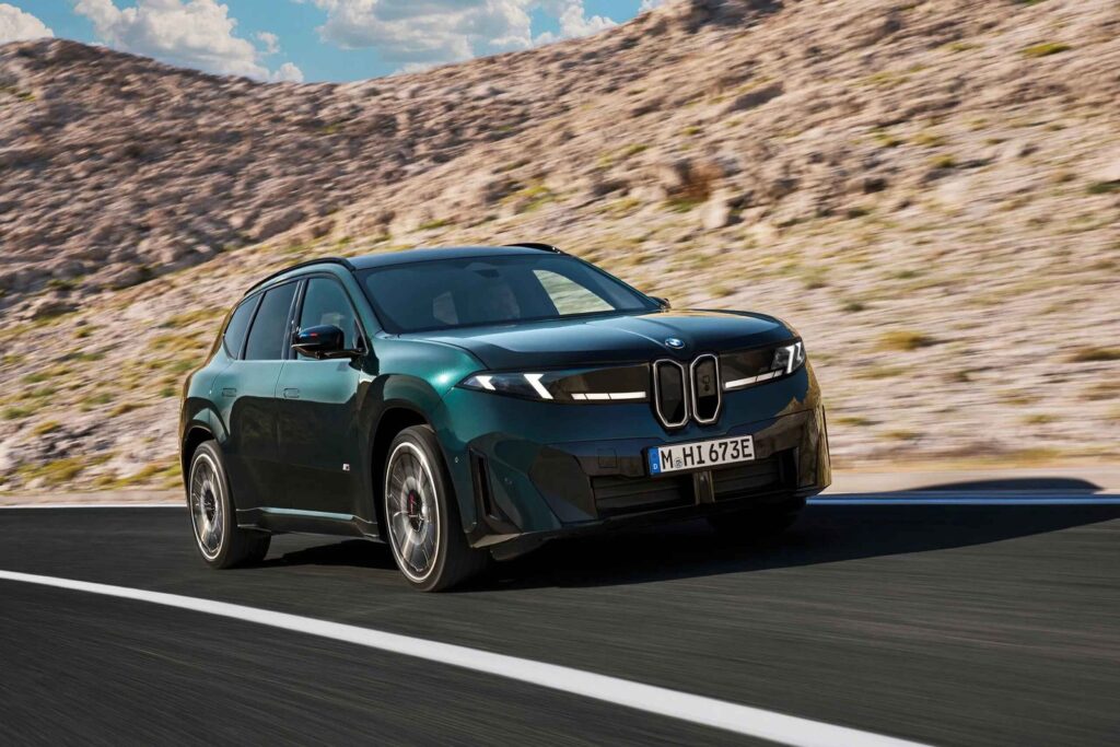 BMW iX3 M60 xDrive electric SUV driving on a modern road