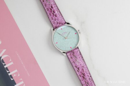 Moriarty Laguna Brings Iridescent Enamel Into Full Colour Moriarty Laguna watch with pale blue iridescent enamel dial, hot pink indexes and purple strap