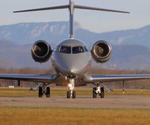Private jet parked on a European airport apron at sunset
