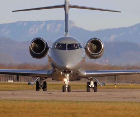 Private jet parked on a European airport apron at sunset