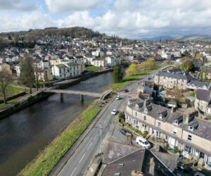 View of Kendal in Cumbria with limestone buildings, greenery and the River Kent