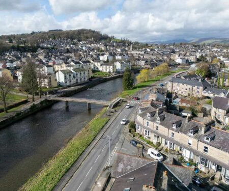 Kendal Named the Best Place to Live in Northern England View of Kendal in Cumbria with limestone buildings, greenery and the River Kent