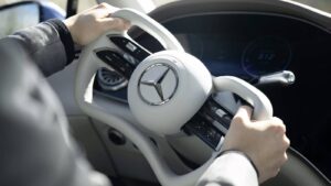 Conceptual adjustable Mercedes-Benz steering wheel inside a modern car cabin