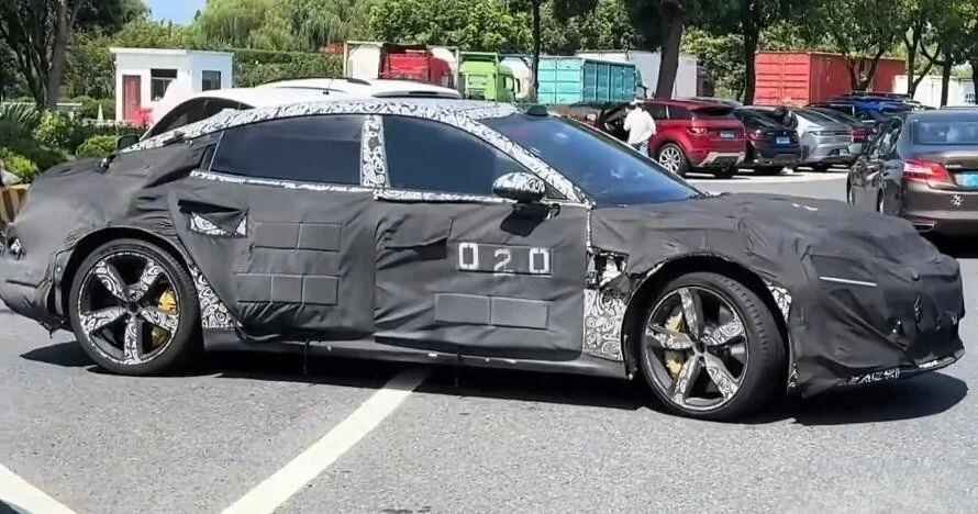 Camouflaged Xiaomi flagship sedan prototype testing on a road