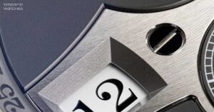 A close-up of a mechanical jumping hour watch with a digital-style hour aperture and refined dial architecture