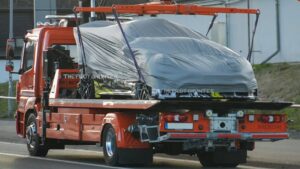 Covered Xiaomi SU7 Ultra Extreme prototype on a flatbed at the Nürburgring