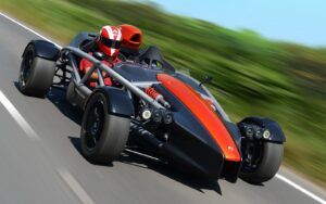 Ariel Atom lightweight sports car on a road with desert landscape
