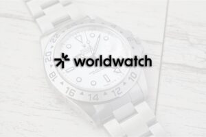 Vintage wristwatch with documents and a loupe on a dealer’s desk