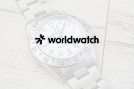 The Pre-Owned Watch Market Needs a Proper Memory Vintage wristwatch with documents and a loupe on a dealer’s desk